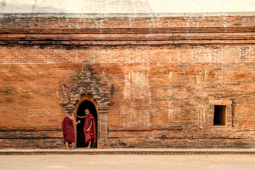 monks standing outside ruins in Bagan