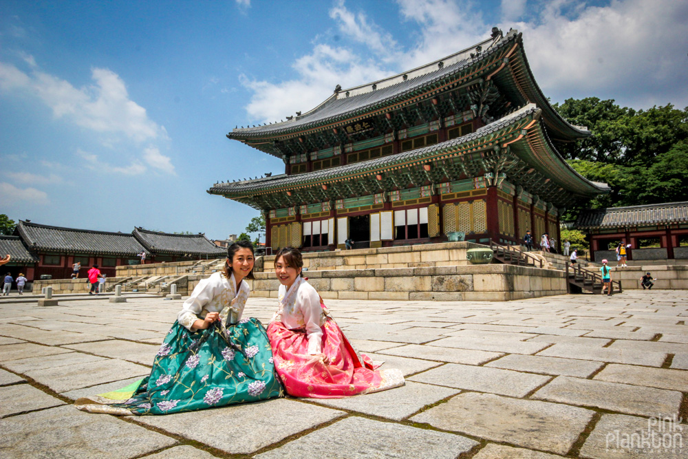 Changdeokgung temple girls in hanboks posing in South Korea