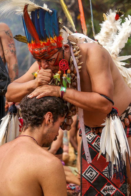 indigenous man performing blessing ceremony on man at Tribal Gathering Festival in Panama