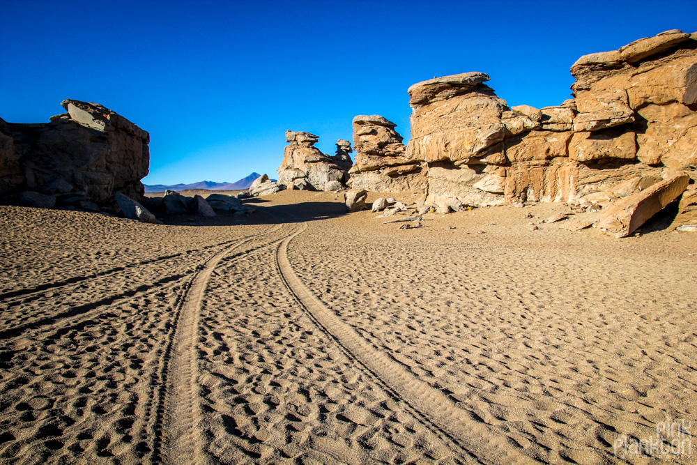 rock formations and sand road in Bolivia's desert