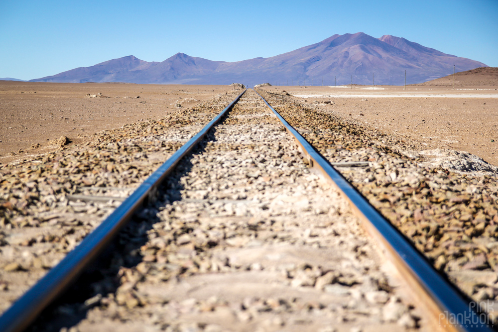 train tracks and distant mountains in Bolivia's desert
