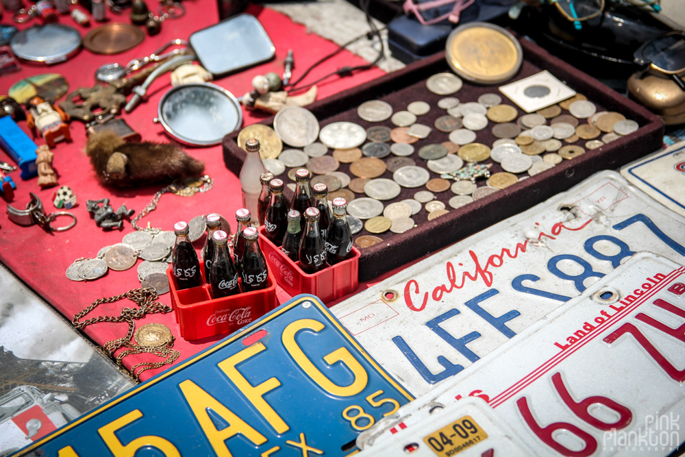 antique license plates, coins, and coke bottles in Mercado La Lagunilla in Mexico City
