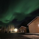 Northern Lights/aurora borealis over cabins in Iceland