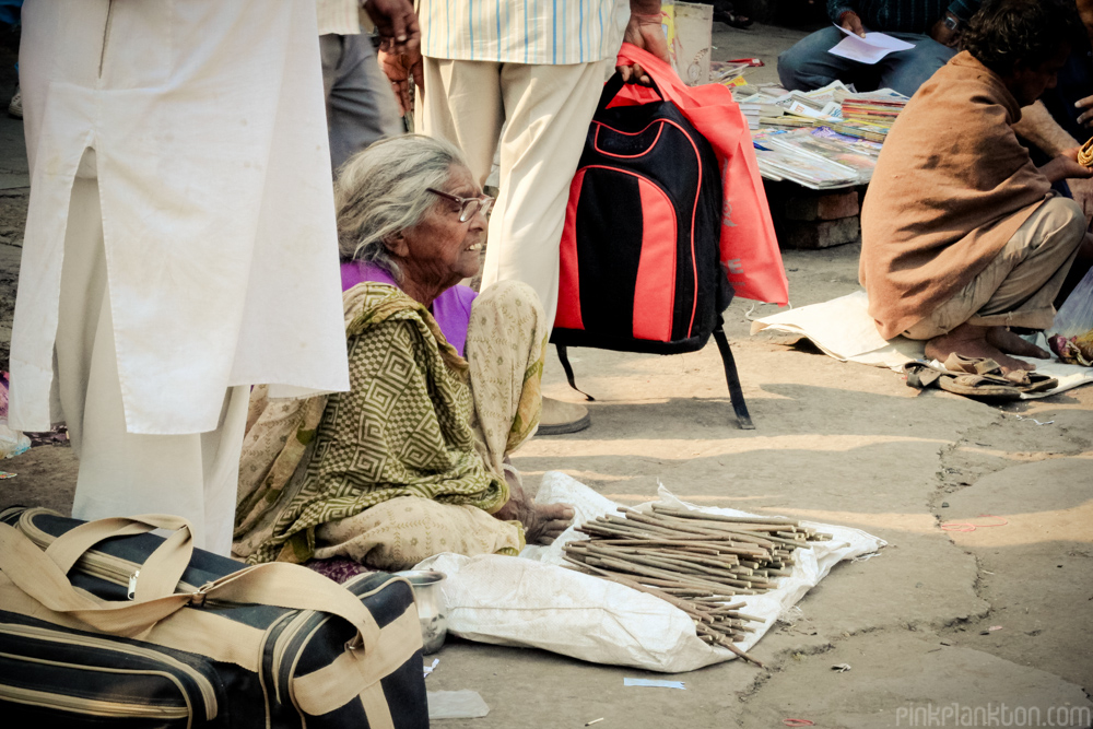 Indian woman selling toothbrushes on street in New Delhi