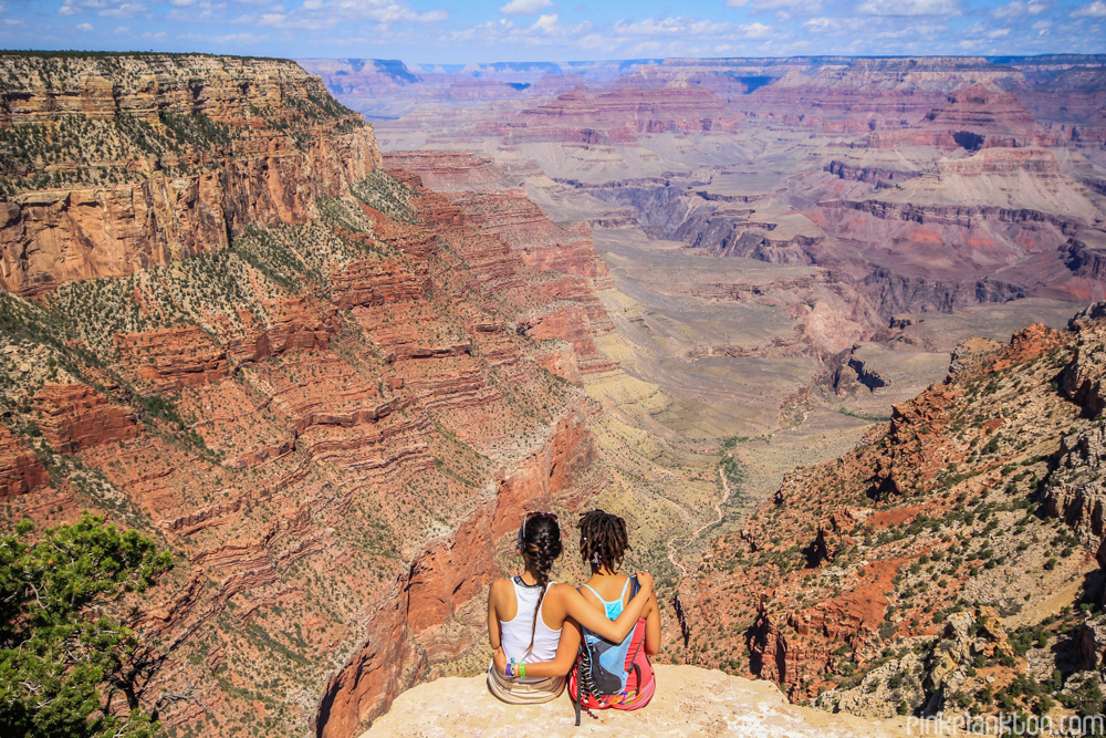 2 girls sitting on the edge of the Grand Canyon in Arizona