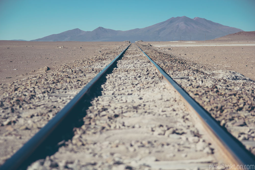 desert train tracks and mountains in Bolivia