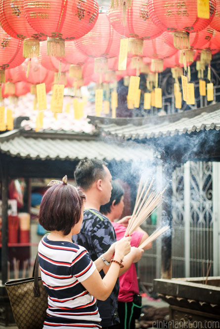 Chinese New Year people burning insence in temple