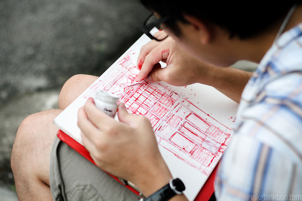 young man sketching colonial architecture of Georgetown, Malaysia