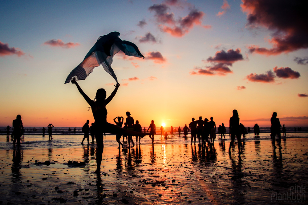 Envision Festival beach at sunset with silk fan dancer