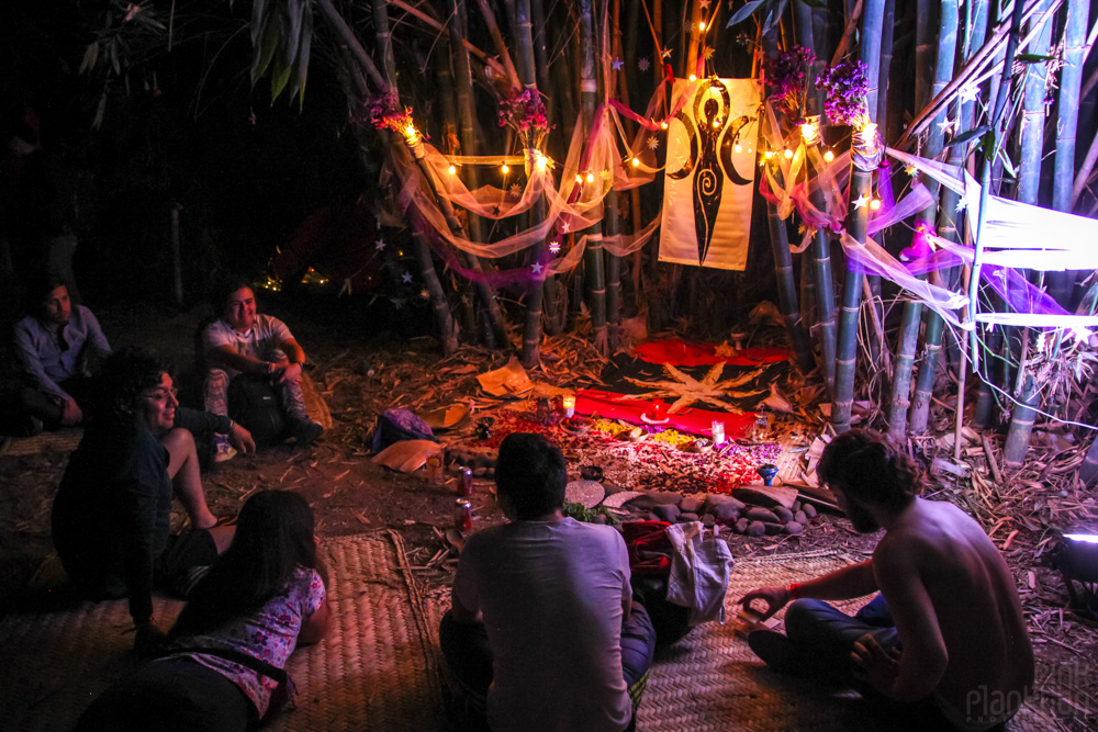 people sitting around altar at night at Festival Ometeotl