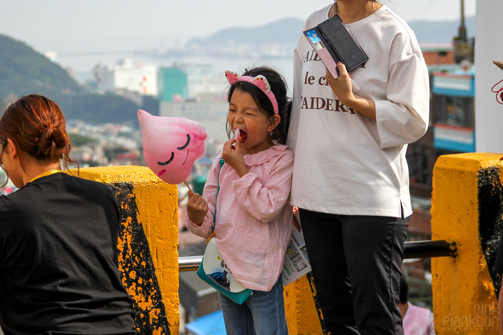 child eating cotton candy with face in Korea