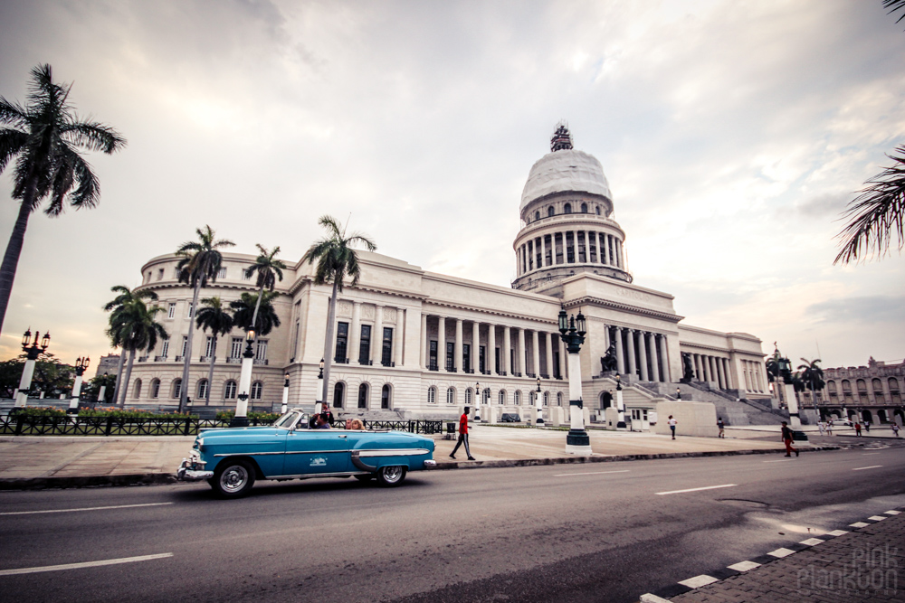 El Capitolio and blue classic car in Havana Cuba