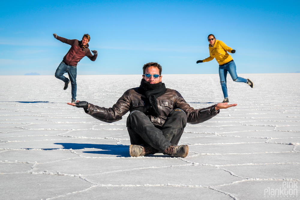 perspective photo of person holding other people on Bolivia's Salar de Uyuni