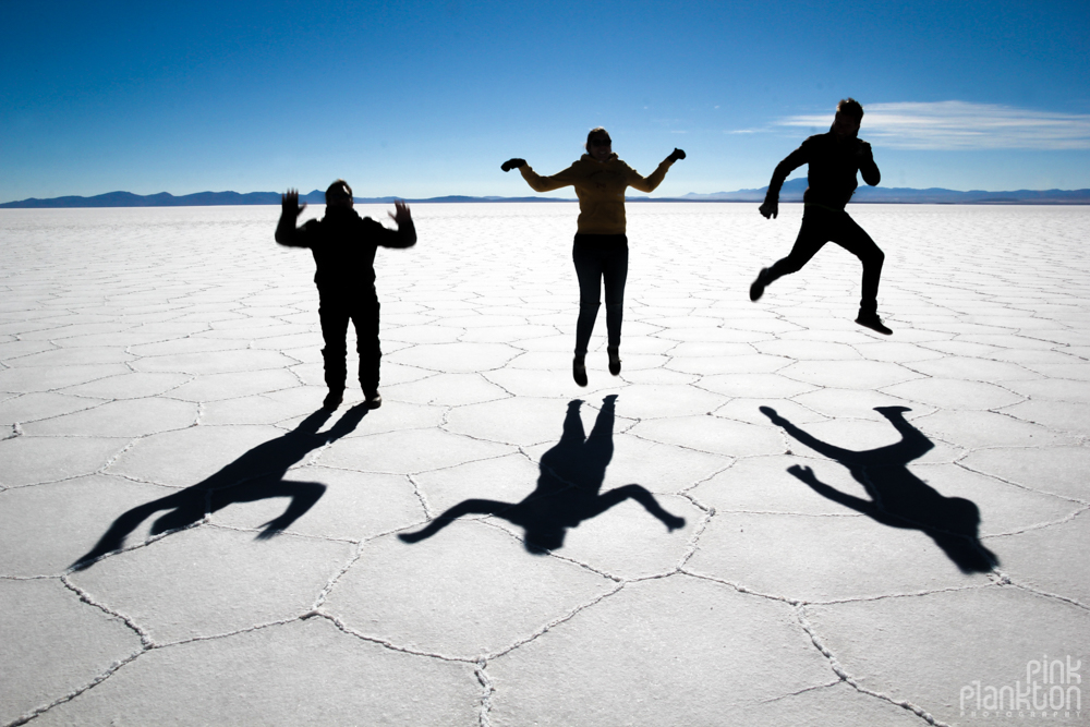 shadows and silhouettes of people on Bolivia's Salar de Uyuni