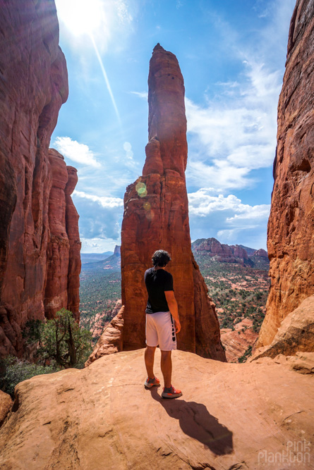 man posing in front of spire in Cathedral Rock in Sedona