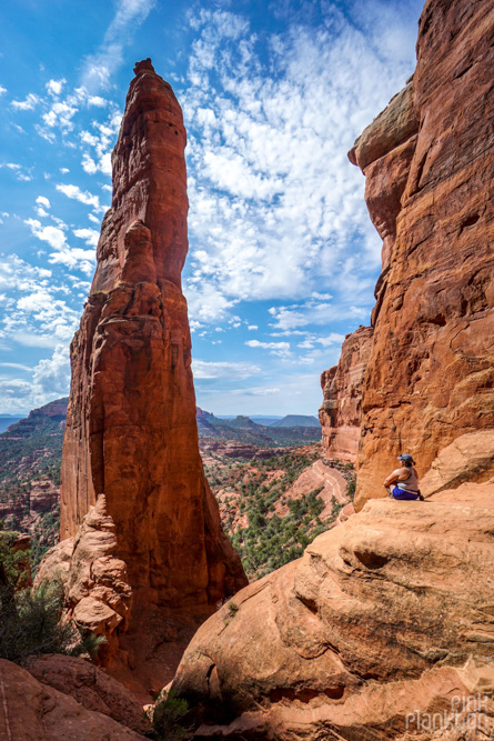 girl sitting near spire in Cathedral Rock in Sedona