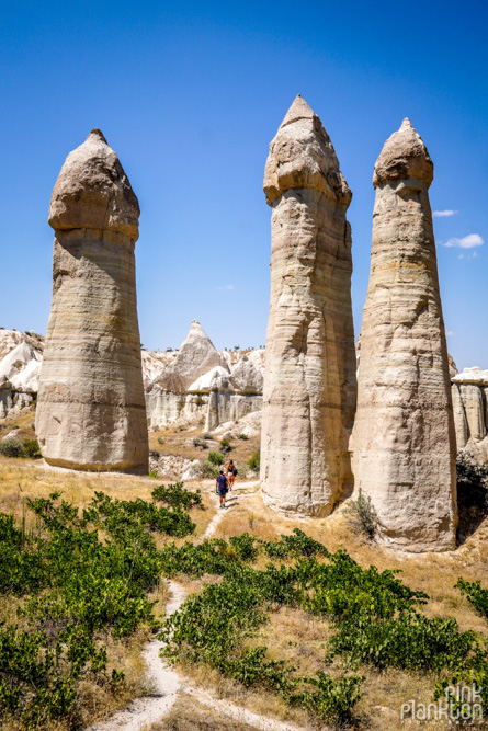 hiker hiking through penis-shaped rocks in Love Valley in Cappadocia, Turkey