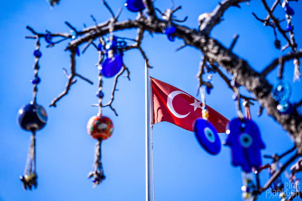 Nazar boncuk evil blue eye with Turkish flag in the background