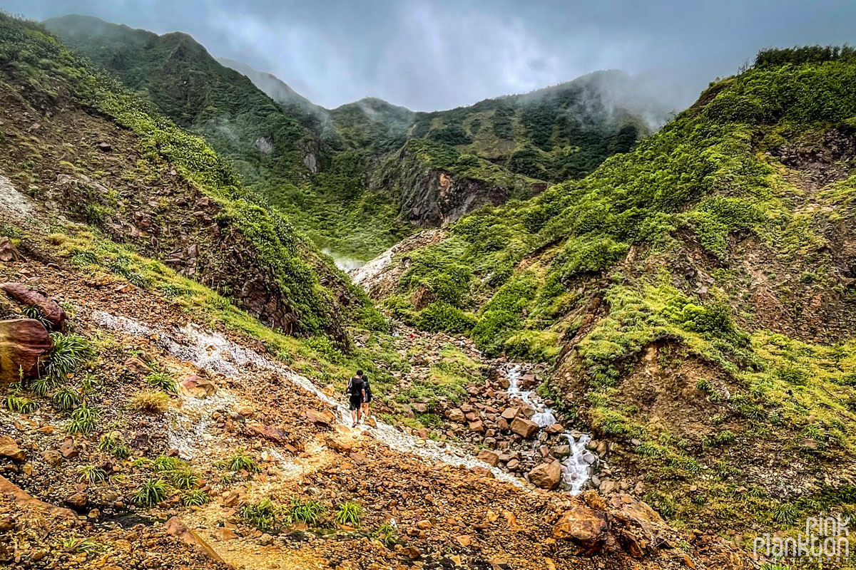Hikers amidst the mountains of the Boiling Lake Hike in Dominica