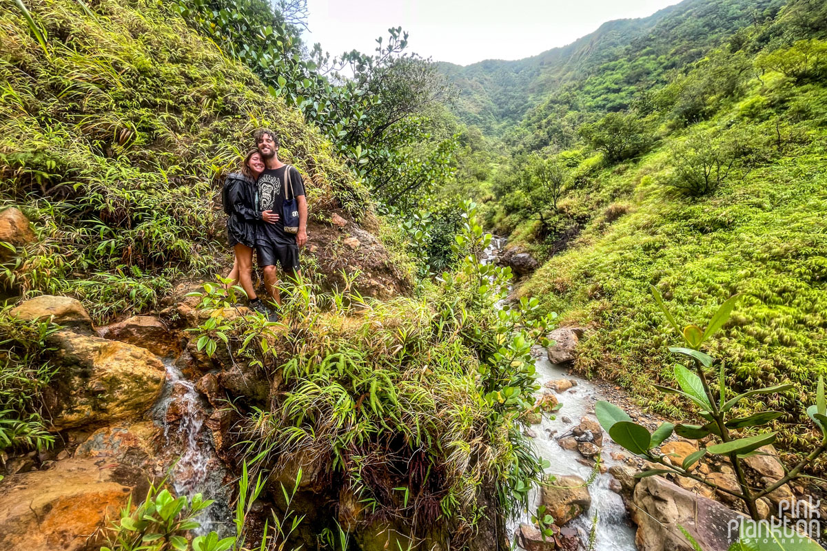 couple standing by a river on the Boiling Lake Hike in Dominica