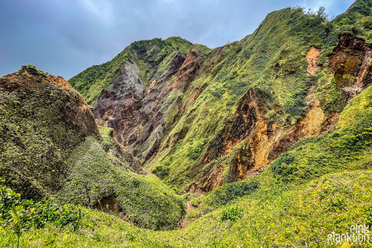 Group of hikers down below in the mountain scenery of the Boiling Lake Hike in Dominica