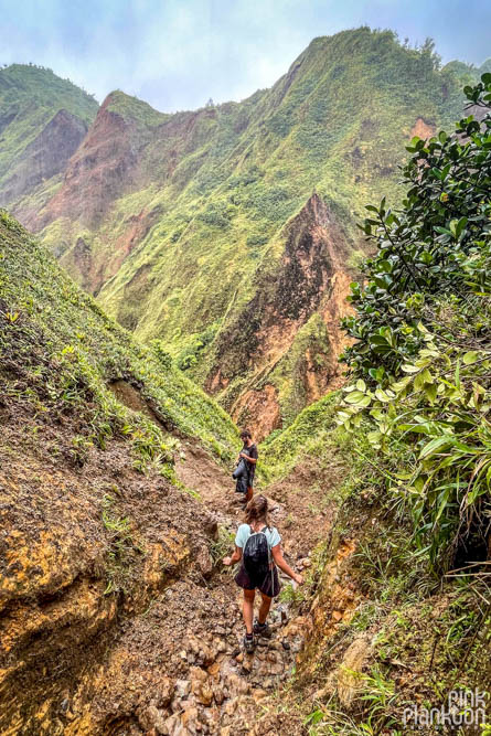 Hikers with mountain scenery along the Boiling Lake Hike in Dominica