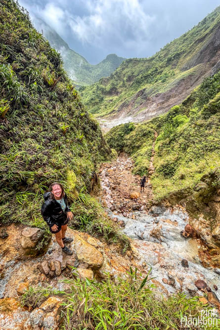 Hiker posing with mountain scenery along the Boiling Lake Hike in Dominica