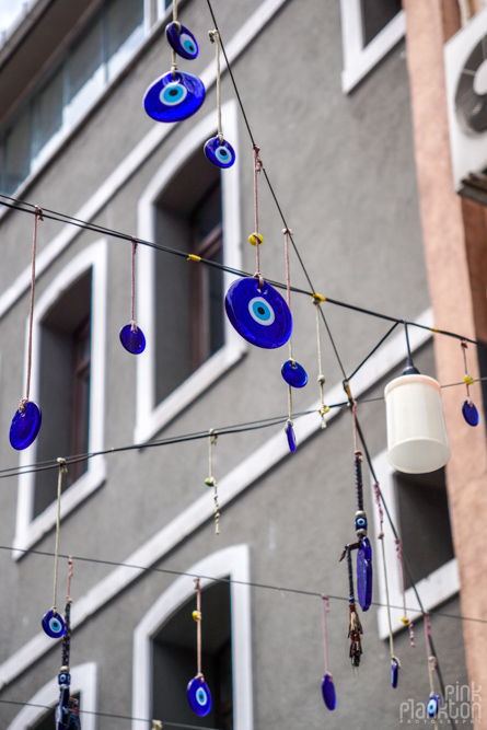 Several Turkish nazar boncuk hanging in the streets of Karakoy, Istanbul