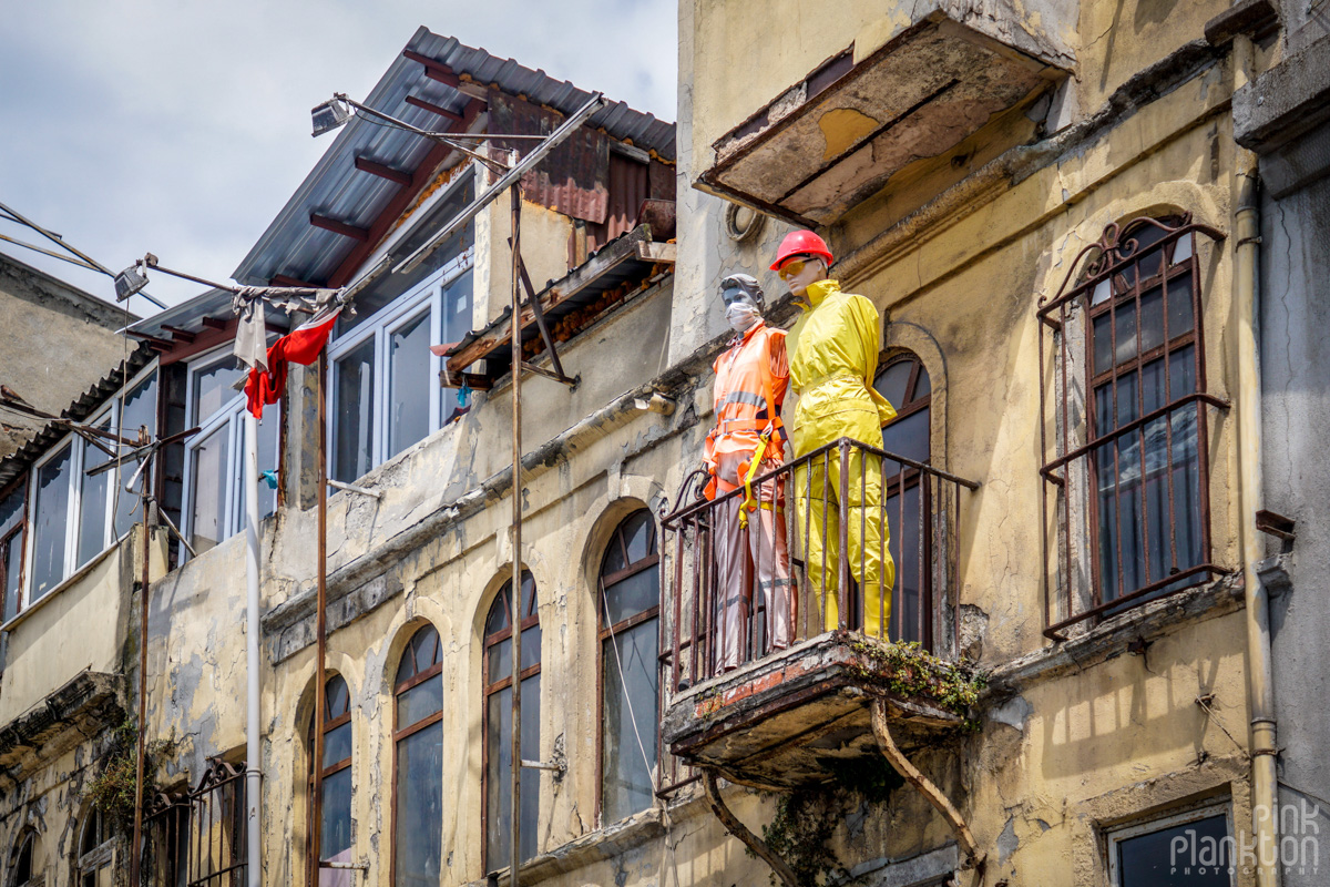 Two mannequins dressed in protective gear in a window sill in Karakoy Istanbul