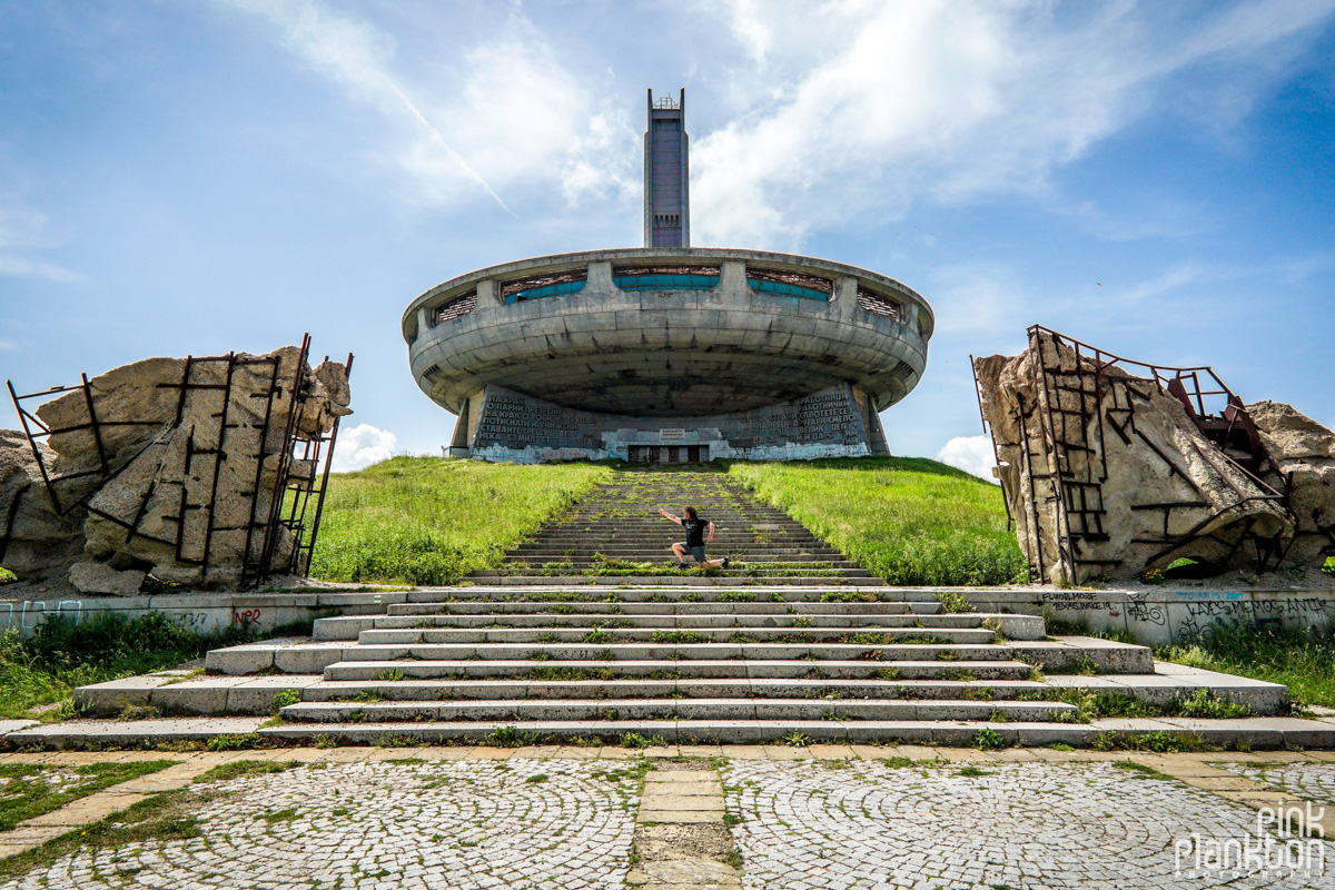 Man posing in front of Buzludzha abandoned Communist monument in Bulgaria