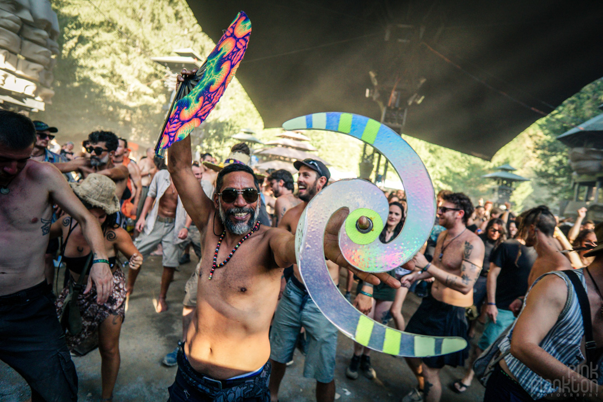 Man dancing with fan and spinning saucer at Modem Festival