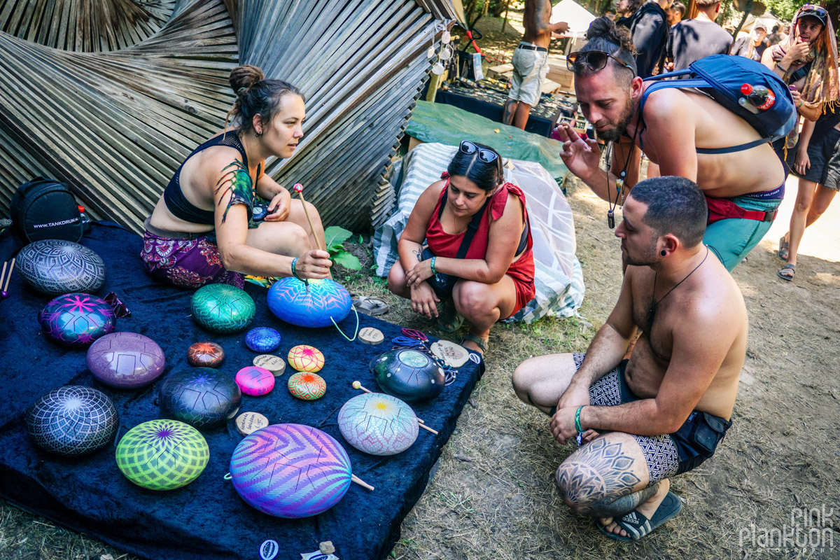 Lady showing handpan drums at pirate market at Modem Festival