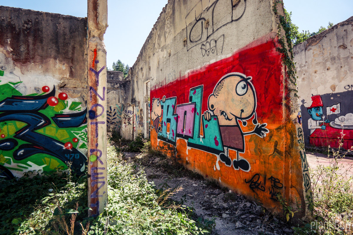 Street art on building near abandoned bobsled track in Sarajevo